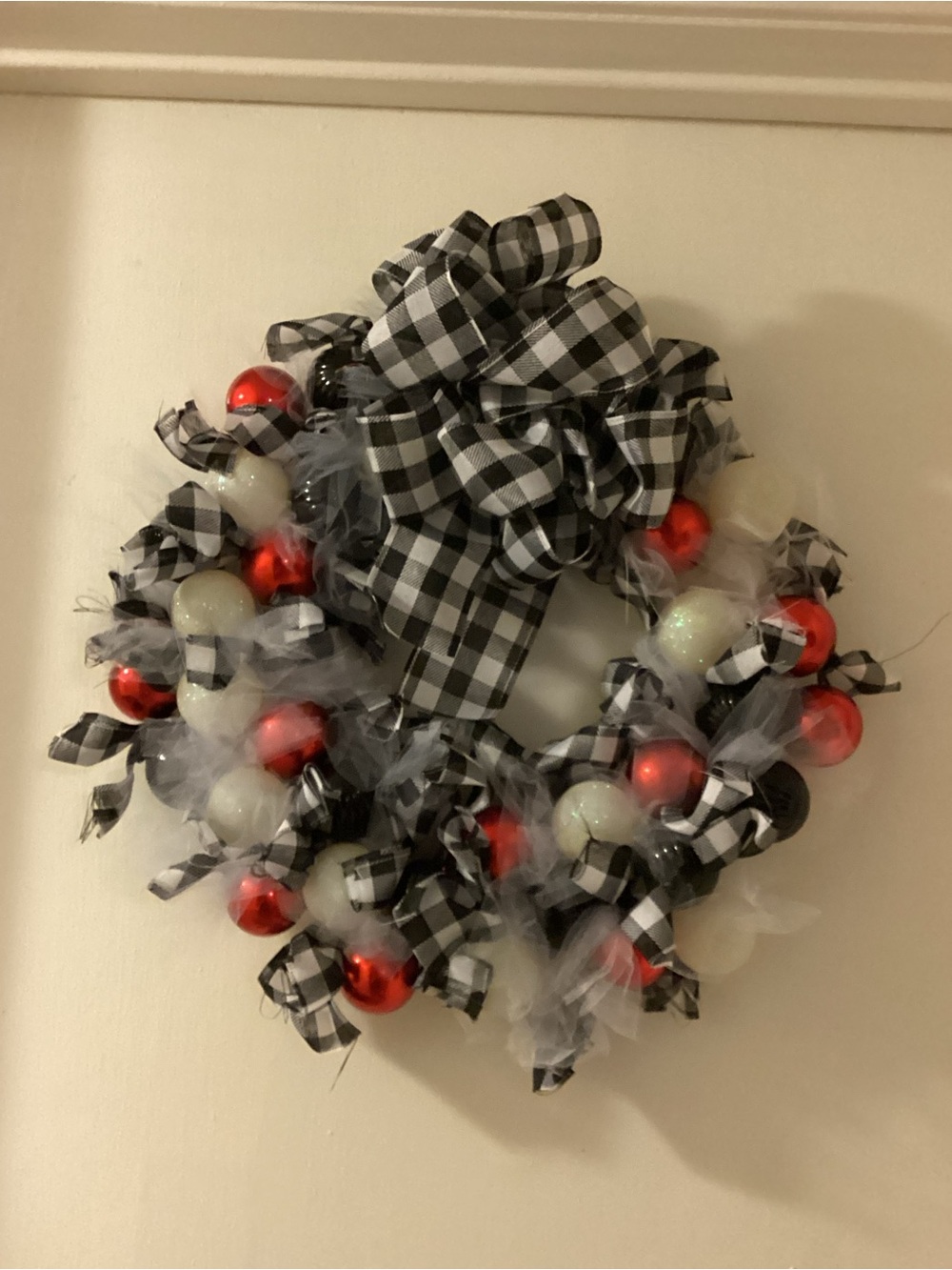 Homemade black-and-white plaid with Christmas balls wreath